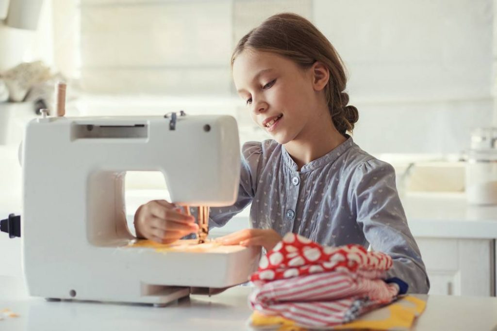 Girl with sewing machine